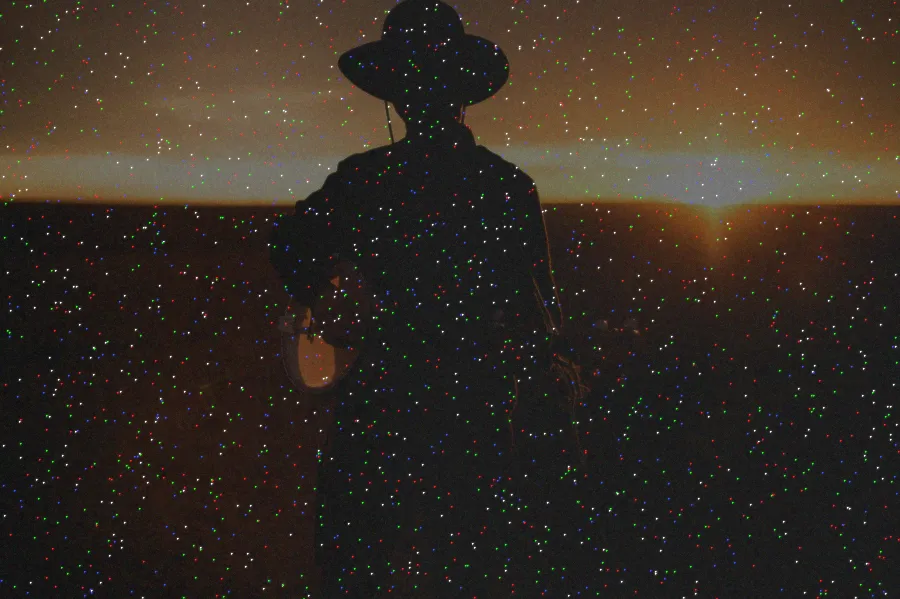 Hot Pixel Noise, applied to “Banjo player sunset (Unsplash)”