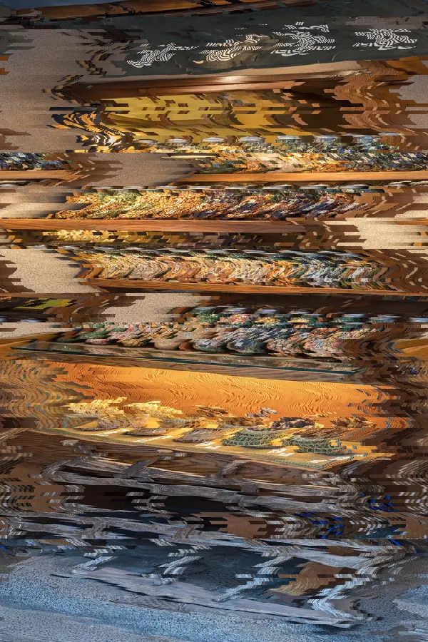 Scanline Displacement, applied to “Illuminated wooden shelf with many glass jars containing cookies for sale in Tok”